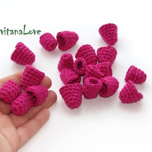 May include: A collection of 16 small, crocheted, pink flower buds.