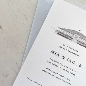 May include: A wedding invitation with a light gray envelope. The invitation features a detailed sketch of a building and the text "SAVE THE DATE FOR THE WEDDING OF MIA & JACOB" along with the wedding date, location, and website address.