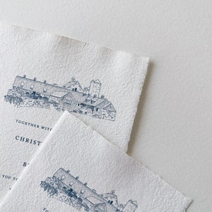 May include: Two off-white textured paper invitations with a blue ink illustration of a building. The text "TOGETHER WITH CHRISTINE" is visible. The paper has a deckled edge.
