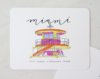 May include: Square card featuring a colorful illustration of a lifeguard tower in Miami. The tower is depicted in shades of pink, orange, yellow, and blue, with the word "miami" written above in cursive. The text "16th Street Lifeguard Tower" is below the illustration.