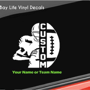 May include: White vinyl decal of a football player with a football and the word "CUSTOM" in a vertical line. The text "Your Name or Team Name" is below the image.