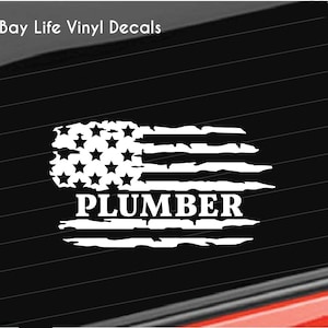 May include: White vinyl decal of a distressed American flag with the word "PLUMBER" underneath.