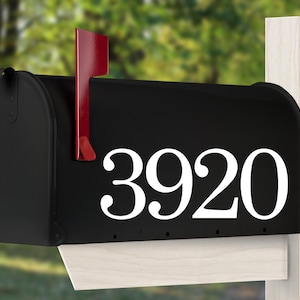 May include: Black mailbox with a red flag and white house numbers 3920.