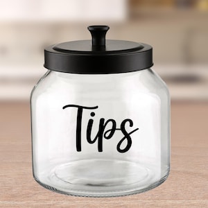 May include: A clear glass jar with a black metal lid and a black vinyl label that says "Tips".