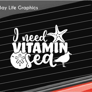 May include: White vinyl decal with the text "I need Vitamin Sea" with a starfish, a seashell, and a seagull.