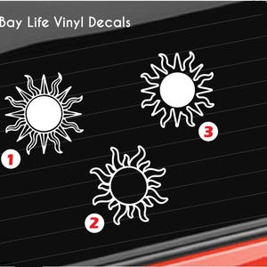 May include: Three white vinyl decals of stylized suns with different designs. The decals are numbered 1, 2, and 3. Bay Life Vinyl Decals is written at the top of the image.