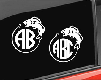 May include: Two white vinyl decals featuring a fish jumping out of the water with a fishing line and a circle monogram. The first decal has the letters "AB" in the circle. The second decal has the letters "ABC" in the circle.