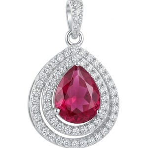 May include: A pear-shaped pendant featuring a vibrant, deep pink center stone surrounded by a double halo of small, clear, sparkling stones. The setting is a polished silver-toned metal, and the bail is also encrusted with small clear stones.