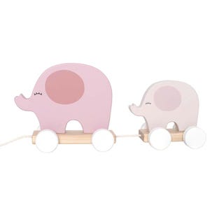 May include: A wooden pull-along toy with two pink elephant figures. The elephants have light pink ear accents and are mounted on a wooden base with white wheels, connected by a string. A charming toy for young children.