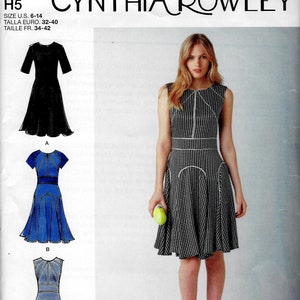 May include: A sewing pattern for a dress with a black and white gingham print. The pattern is for sizes 6-14 and includes instructions for three different styles. The pattern is from Simplicity and is designed by Cynthia Rowley.