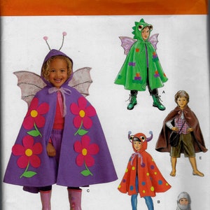 May include: Simplicity sewing pattern 1769A for children's costumes. The pattern includes four different costumes: a butterfly, a dragon, a ladybug, and a knight. The butterfly costume is purple with pink flowers, the dragon costume is green with purple accents, the ladybug costume is red with black dots, and the knight costume is black with a silver sword.