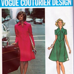 May include: A vintage sewing pattern for a dress with a V-neckline and a zipper closure. The pattern is from Vogue Couturier Design and is labeled #2831. The dress is shown in two versions: a pink version with a long sleeve and a green version with a short sleeve.
