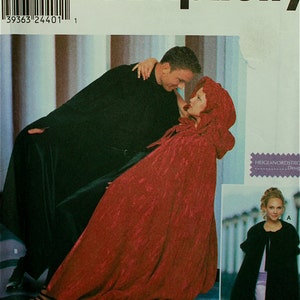 May include: Simplicity sewing pattern number 9452 for a cape. The pattern includes two styles: a black cape with a hood and a red cape with a hood. The pattern is for sizes S, M, and L.