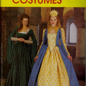 May include: McCall's Costumes pattern showing two Renaissance gowns. One is emerald green with long sleeves, the other is blue and yellow with a floral pattern and a crown. The text "McCall's Costumes" is at the top.