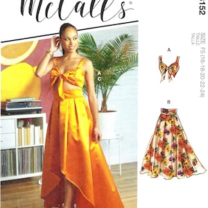 May include: McCall's sewing pattern M8152 for sizes 16-18-20-22-24. The pattern includes instructions for a crop top with a bow and a high-low skirt. The model is wearing a yellow version of the outfit, and the pattern also includes a floral skirt option.