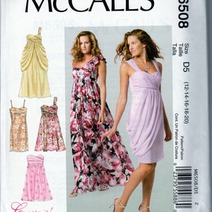 May include: McCall's M6508 sewing pattern featuring illustrations of several women's dresses. The dresses include a yellow draped dress, a floral print maxi dress, and a lavender draped mini dress. The pattern includes the text "Create it!"