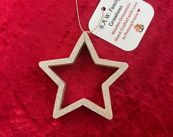 Hand-crafted wooden star ornament with silver glitter. Please see description for more information.