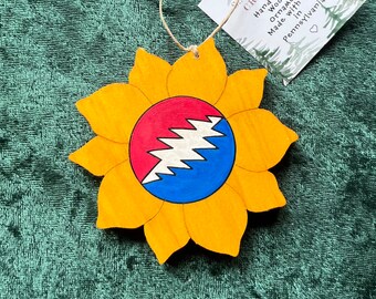Hand-crafted wooden red and blue bolt sunflower ornament. Please see description for more information.