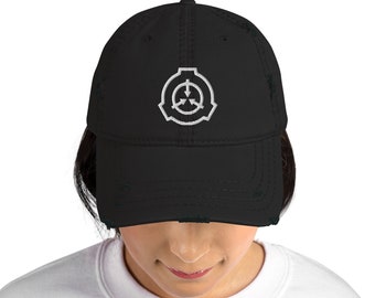 May include: A black distressed baseball cap with a white embroidered logo of a triangle with an arrow pointing down and a circle inside. The logo is the symbol for the SCP Foundation.