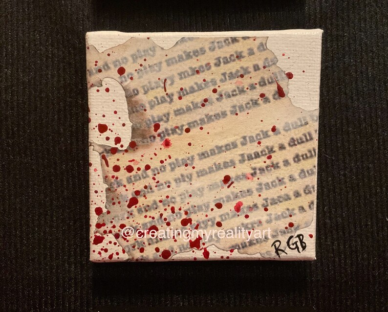 Puede incluir: Una peque&ntilde;a pintura sobre lienzo con fondo blanco y salpicaduras de pintura roja. El lienzo est&aacute; rasgado y se puede ver el texto "and no play makes Jack a dull boy". La pintura est&aacute; firmada "RGB" en la esquina inferior derecha.