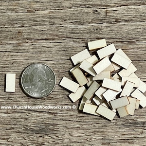 May include: A pile of small, unfinished, rectangular wooden pieces, approximately the size of a US quarter. The pieces are light brown in color and have a smooth, sanded surface. www.ChurchHouseWoodworks.com
