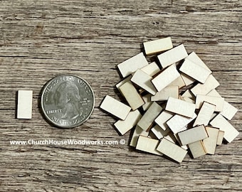May include: A pile of small, unfinished, rectangular wooden pieces, approximately the size of a US quarter. The pieces are light brown in color and have a smooth, sanded surface. www.ChurchHouseWoodworks.com