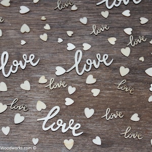 May include: A wooden background with scattered wooden hearts and the word "love" written in cursive. The word "love" is repeated multiple times in different sizes and styles.