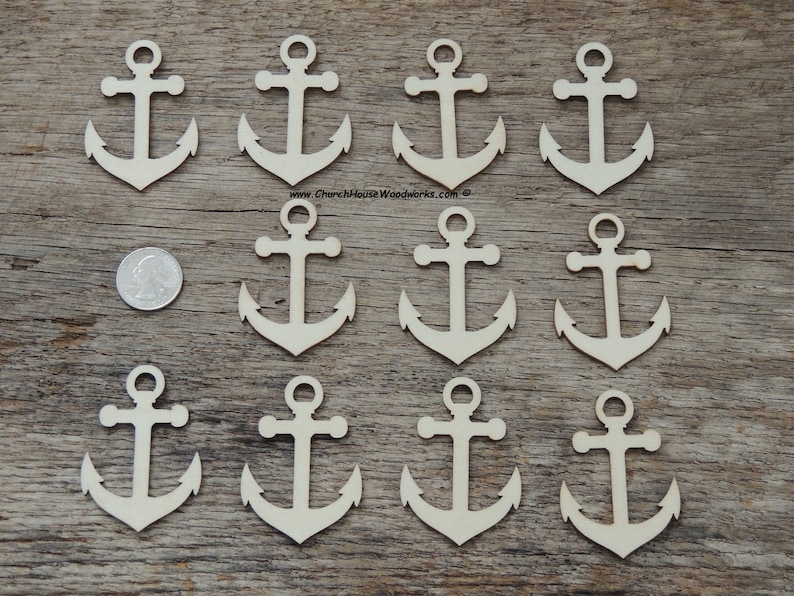 May include: Twelve unfinished wooden anchor shapes, each with a hole at the top for hanging. The anchors are approximately 2 inches tall and are arranged in four rows of three on a wooden surface.