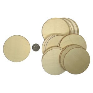 May include: A stack of 15 unfinished wooden circles, each measuring 3 inches in diameter. The circles are arranged in a pile, with the top circle slightly offset from the others. A single wooden circle is shown to the left of the stack, for size comparison.