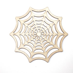 May include: A wooden cutout of a spider web, perfect for Halloween decorations. The web is detailed and intricate, with a circular design in the center.