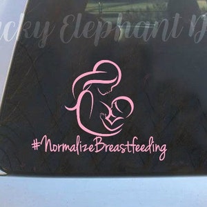 May include: Pink vinyl decal of a mother breastfeeding a baby with the text "#NormalizeBreastfeeding" on a silver car window.