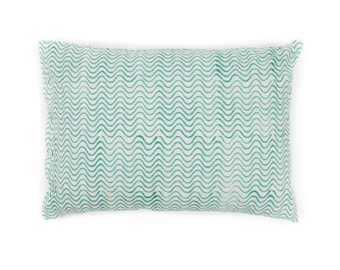 May include: A white pillow with a teal wave pattern.