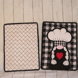 May include: A pair of black and white checkered fabric pot holders with a white chef hat gnome design on one side. The other side is plain black and white.