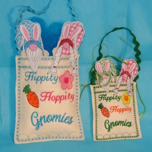 May include: Two Easter bunny gnome bags with green, pink, and blue bunny ears. The larger bag has the text "Hippity Hoppity Gnomes" and the smaller bag has the text "Hippity Hoppity Gnomes".