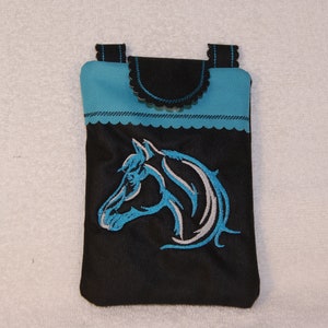 May include: A black phone case with a blue trim and a white horse head design embroidered on the front.