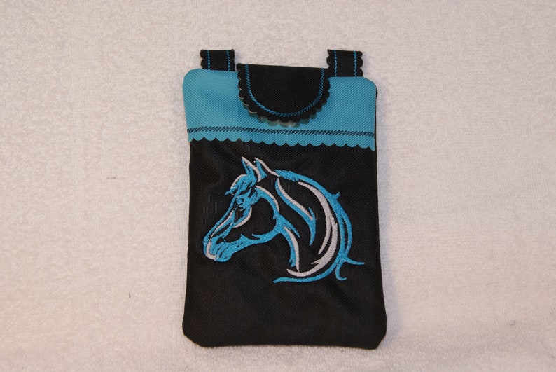 May include: A black phone case with a blue trim and a white horse head design embroidered on the front.