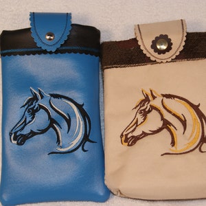 May include: Two phone cases with embroidered horse head designs. One case is blue with a white and black horse head, the other is beige with a brown and gold horse head.