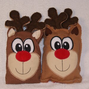 May include: Two brown plush reindeer ornaments with embroidered faces, red noses, and brown antlers.