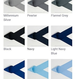 May include: A collection of 12 ribbon samples in various colors, including white, antique white, shell grey, millennium silver, pewter, flannel grey, black, navy, light navy blue, dark royal blue, blue, millennium blue, bluebird, denim, and aqua.