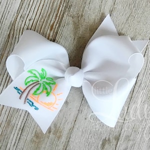 May include: White hair bow with a colorful embroidered design of a palm tree and a sunset.