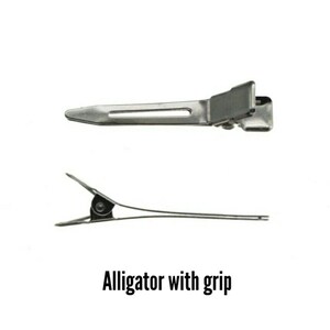 May include: Two silver-colored alligator hair clips are displayed against a white background. The top clip is viewed from the side, showing its flat, rectangular design. The bottom clip is open, revealing its pointed teeth and hinge.