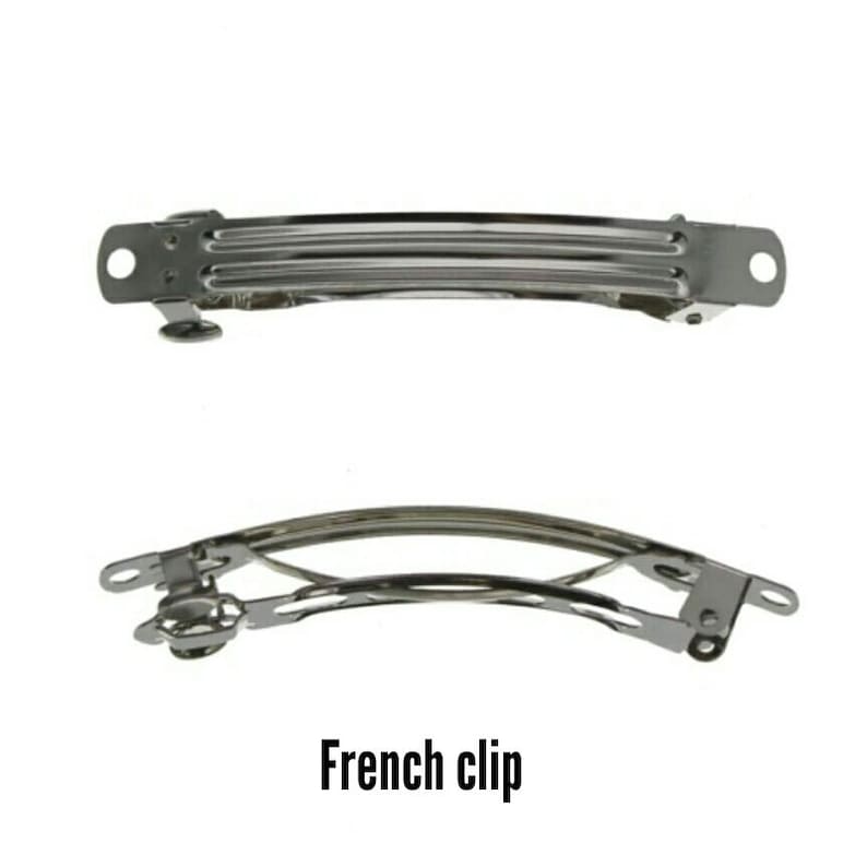 May include: Two silver-colored French hair clips are displayed against a white background. The top clip is rectangular with a series of parallel bars. The bottom clip is curved with a hinged mechanism. The text "French clip" is below the clips.