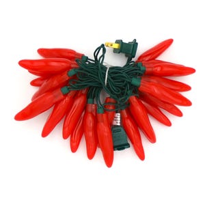 May include: A string of red chili pepper shaped Christmas lights with a green wire and a standard plug.