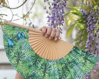 BLUE WINGS: Luscious green ferns with two blue butterflies folding hand fan with natural wood ribs