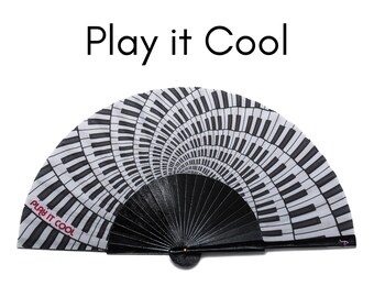 PLAY IT COOL: Black and white piano keyboard design with fuchsia color text folding hand fan with black wood ribs - perfect for music lovers