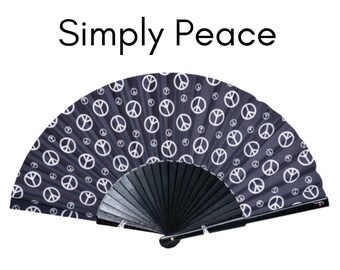 SIMPLY PEACE: 70s retro style folding hand fan with white peace signs on a black background and black wood ribs