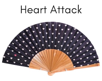 HEART ATTACK: Handheld fan, small white hearts on a black background with one red heart on the side and natural wood lacquered ribs