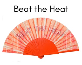BEAT THE HEAT: Graffiti style text on a fiery orange color background folding hand fan with orange wood ribs