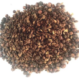 May include: A close-up of a pile of dried brown and black peppercorns.
