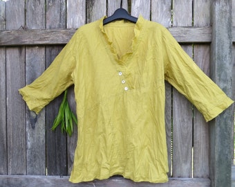 Loose fitting Linen top  with V neck, three quarter sleeves  and raw edge  trims has assymetric details.
